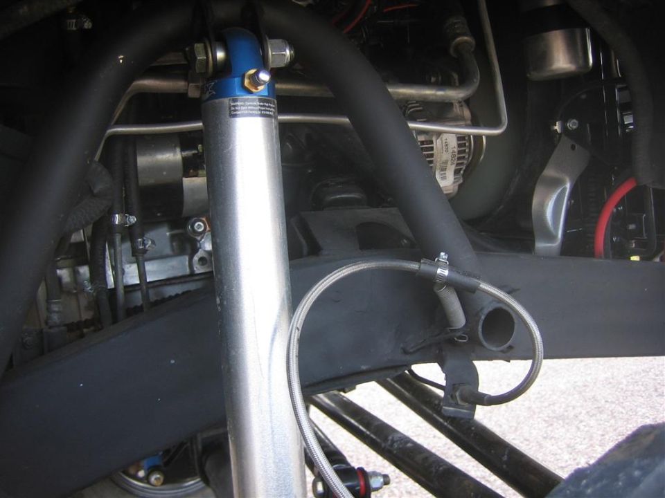 Underbody detail with alloy steering ram, blue end mount and braided brake line