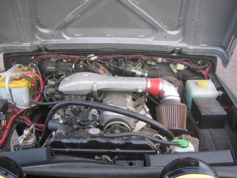 1987 Suzuki Samurai - Engine bay with custom intake and air filter. The vehicle is not clearly identifiable.
