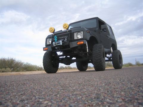 1987 Suzuki Samurai - This modified 1987 Suzuki Samurai features large tires and custom smiley face lights.