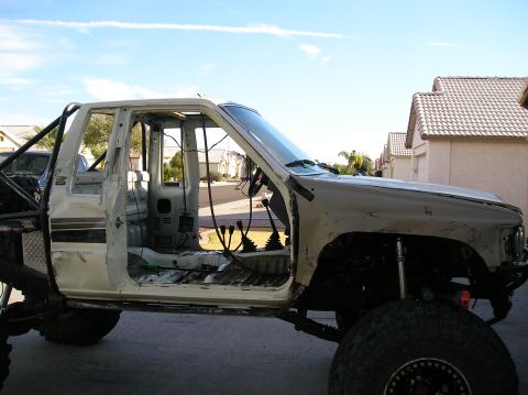 1986 Toyota Hilux - Modified 1986 Toyota Hilux chassis stripped down for custom build, showing interior and roll cage.