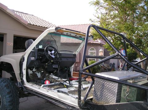 1986 Toyota Hilux - This 1986 Toyota Hilux features a custom roll cage and is shown with its doors removed, revealing the interior.