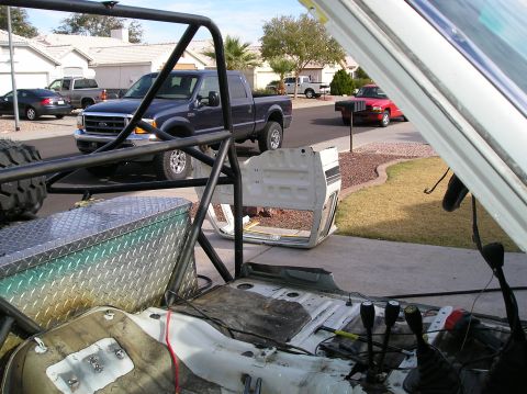1986 Toyota Hilux - Vehicle interior and exterior parts are laid out, with other vehicles in the background.