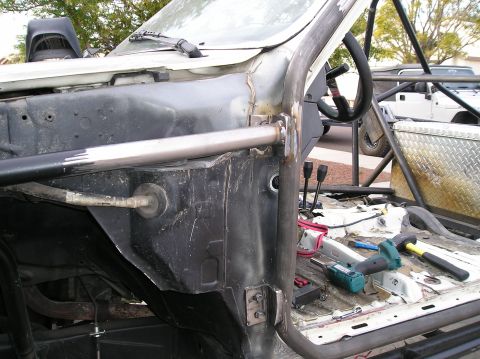 1986 Toyota Hilux - The interior of a truck is visible, a roll cage and tools on the floor.