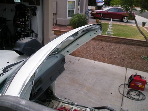 1986 Toyota Hilux - The interior of a car is exposed, with a welder and cables ready for work on the driveway.