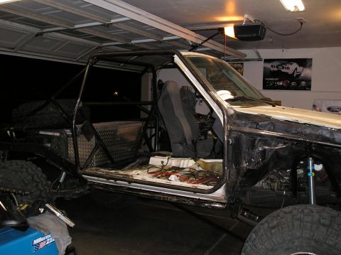 1986 Toyota Hilux - This truck is undergoing modifications with a prominent roll cage installed.