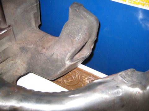 1953 Ford Mainline - This is a close-up view of an engine exhaust manifold part, not a complete vehicle.