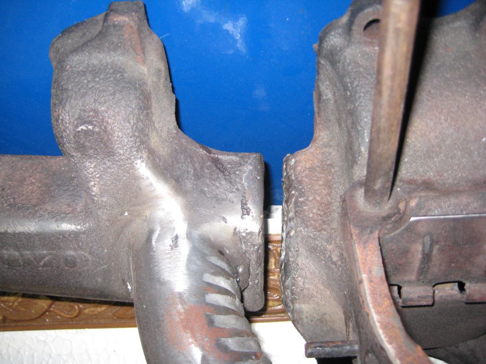 Two cast iron exhaust manifolds, one with a ribbed section