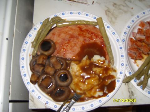 1989 Ford Bronco - A meal meatloaf, mashed potatoes, mushrooms, and asparagus is served on a plate, with another plate of food nearby.