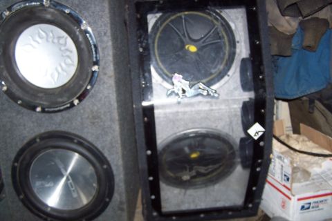 1987 Ford Bronco II - A close-up view of car subwoofers, one a flame design and another with an Eclipse logo.