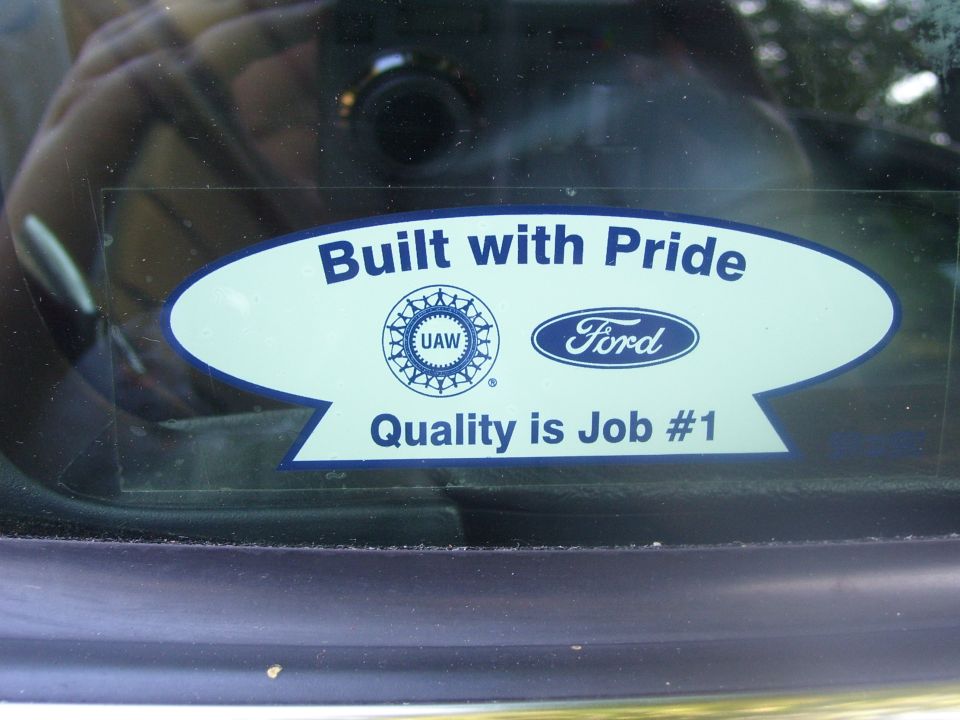 UAW/Ford 'Built with Pride, Quality is Job #1' sticker on a car window