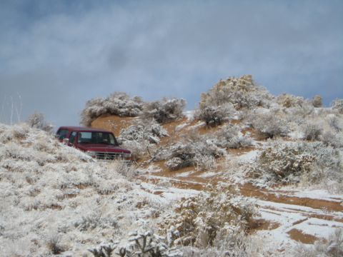 1993 Ford Bronco - An excavator works within a mound of debris, suggesting a demolition or cleanup site.