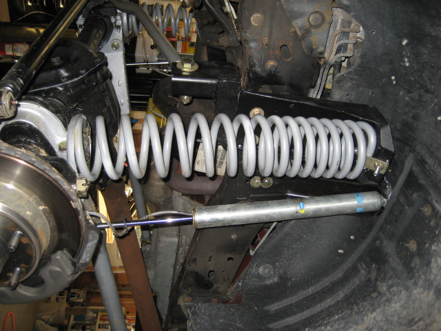 1996 Ford Bronco front suspension with coil spring and shock absorber.