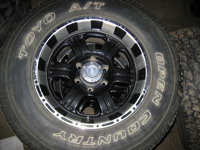 Black Pro Comp eight-spoke wheel on a raised-white-letter Toyo Open Country A/T tire