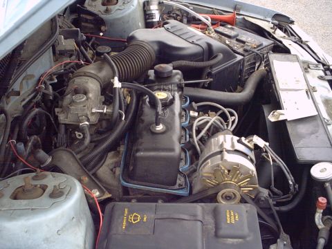 1986 Ford Taurus - Close-up view of a car's engine compartment, showing various mechanical components and wiring.