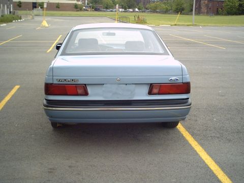 1986 Ford Taurus - Rear view of a 1986 Ford Taurus sedan in a parking lot.