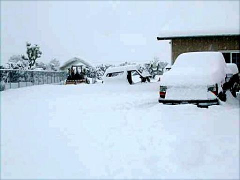 1996 Ford Bronco - A winter scene with vehicles and structures blanketed in snow.