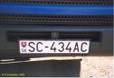 1979 Ford Bronco - A close-up rear view of a white license plate with black text that reads "SC-434AC" is mounted on a dark blue vehicle. The plate has a Slov…