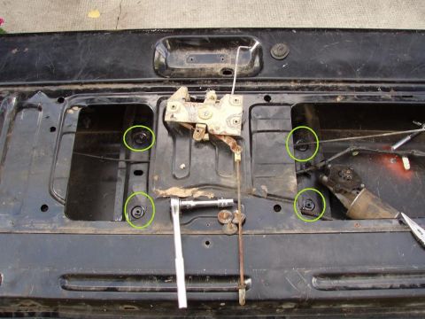 1992 Ford Bronco - these are 4 of the 5 bolts you have to remove to get the motor, and swing arm mechanism out. also, this is the latch mechanism (how it woul…