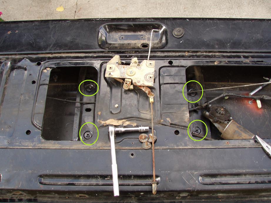 these are 4 of the 5 bolts you have to remove to get the motor, and swing arm mechanism out.

also, this is the latch mechanism (how it would look if it were bolted underneath)