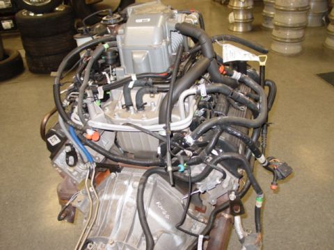 2007 Ford Mustang - Photograph of a Ford engine with intake and wiring, not a technical document.