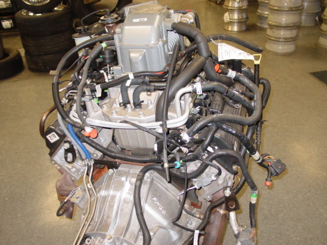 V-engine with intake manifold and hoses on a pallet in a shop