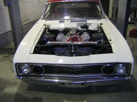 1969 Mercury Cyclone - Front view of a 1969 Mercury Cyclone with its hood open, revealing the engine compartment.