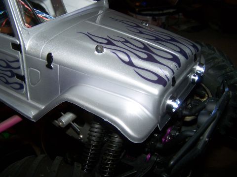 1975 Toyota Land Cruiser - Close-up of a silver remote control car body purple flame graphics and chrome accents.