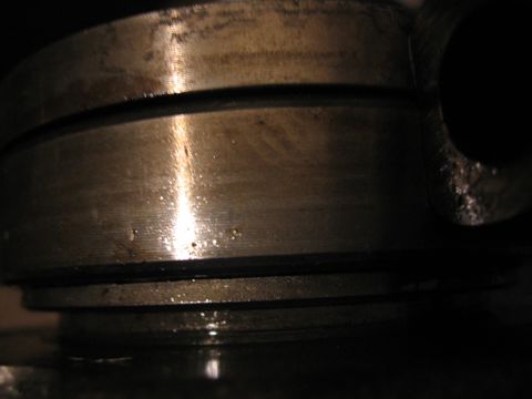 1989 Ford Bronco - A close-up view of a metal bearing assembly, showing signs of wear and lubrication.