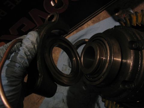 1989 Ford Bronco - Close-up of differential gears and bearing races being handled.
