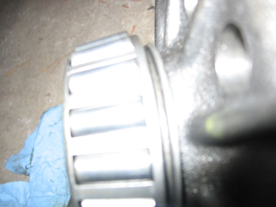 Close-up of a metal gear with a blue cloth on the left