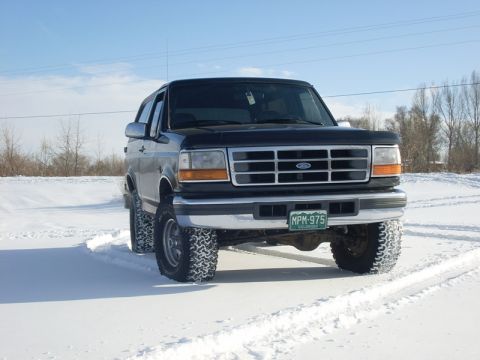 1996 Ford Bronco - This 1996 Ford Bronco is equipped with off-road tires and is navigating a snowy landscape.