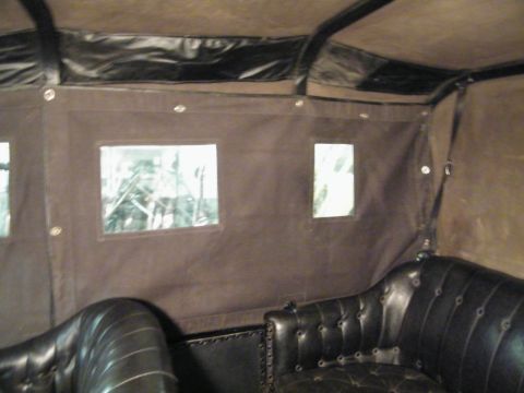 1915 Ford Model T - Interior view of a 1915 Ford Model T, highlighting its classic leather seating and canvas roof.