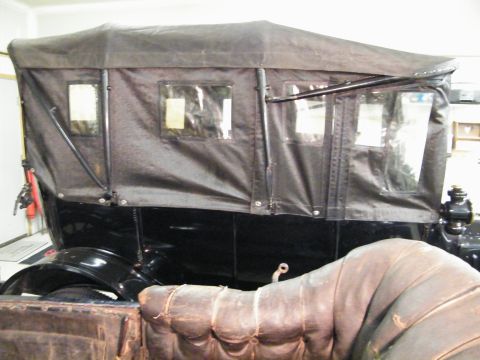 1915 Ford Model T - This touring car features a black fabric top with multiple windows and a dark body.