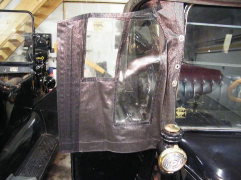 1915 Ford Model T - A close-up of a vintage car's side door, clear windows and fabric construction.