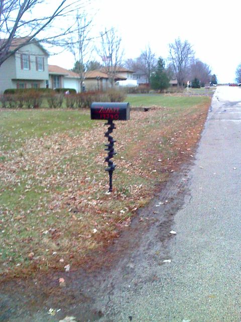 1992 Ford Bronco - A mailbox stands in a residential area, with houses and trees visible in the background.
