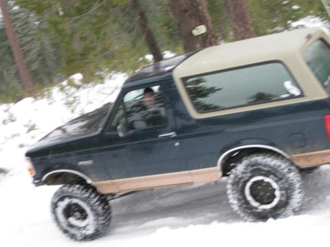 1995 Ford Bronco - Ford Bronco navigates a snowy terrain, its off-road capability.