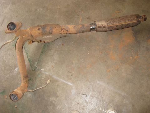 1995 Ford Bronco - This is a rusty exhaust pipe and catalytic converter assembly, likely removed from a vehicle.