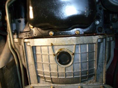 2007 Ford Mustang - Close-up of an engine oil pan, showing a date stamp indicating April 2006.
