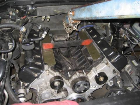 2007 Ford Mustang - Close-up view of a vehicle's engine bay, showing internal engine components and associated wiring.