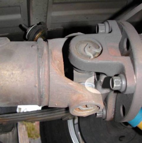 2007 Ford Mustang - Close-up view of a vehicle's driveshaft U-joint connecting to the differential.