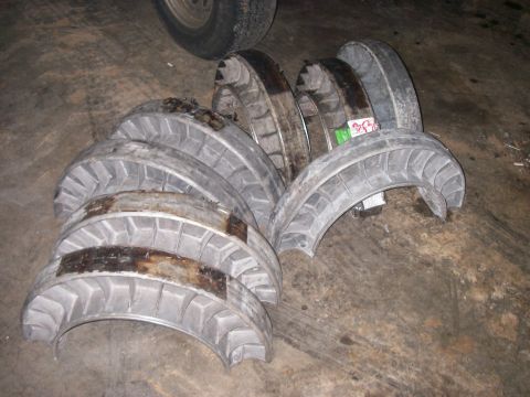 1978 Ford Bronco - Several engine bearings are laid out on a garage floor, with a tire visible in the background.