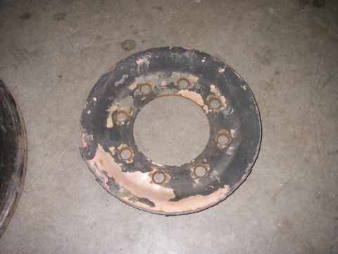 1978 Ford Bronco - A single, heavily worn wheel rim is shown against a concrete surface.