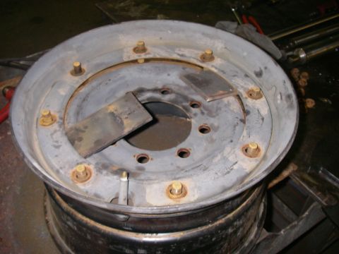 1978 Ford Bronco - A close-up view of a modified wheel rim, welded metal plates and lug nuts, suggesting custom modifications.