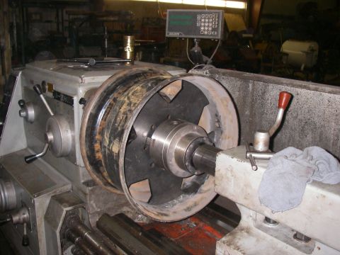 1978 Ford Bronco - Machining a wheel on a lathe in a workshop setting.