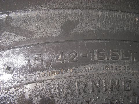 1978 Ford Bronco - Close-up of tire sidewall markings, including size and rim approval information.