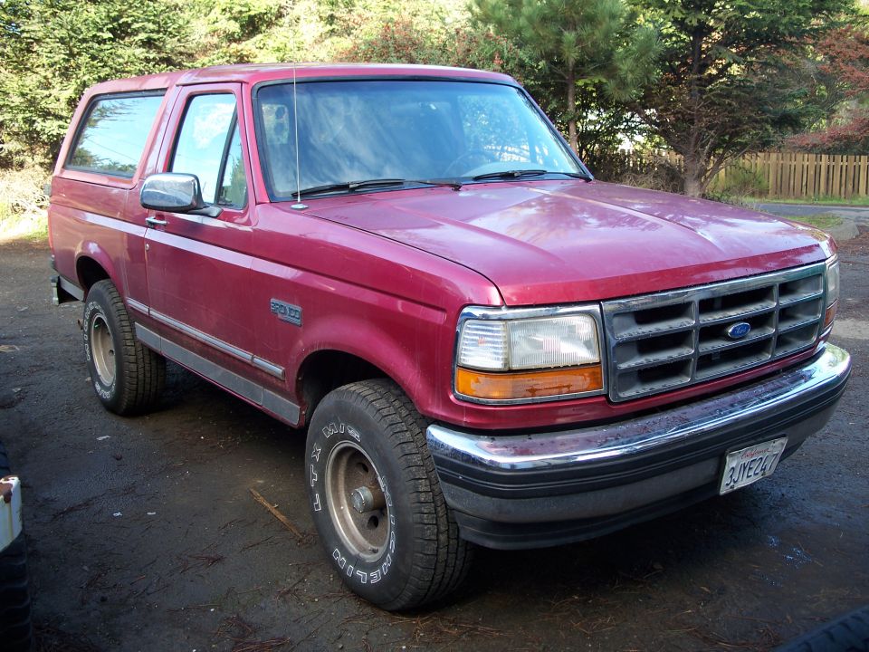 Red Ford Bronco, front quarter view. License plate reads 3JYE247