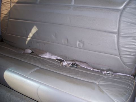 1977 Ford F-150 - Interior view of a gray bench seat with a seatbelt.