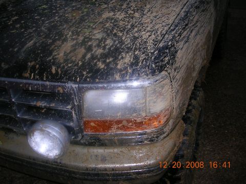 1994 Ford Bronco - This heavily mud-splattered SUV shows a grille design consistent with the early to mid-1990s.