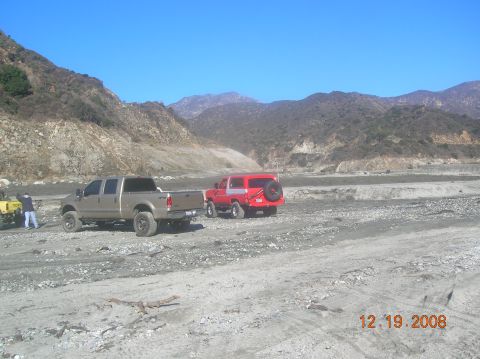 1985 Ford Bronco - A red SUV is parked in a dry riverbed with mountains in the background. A date stamp shows 12.19.2008.