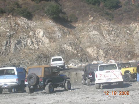 1985 Ford Bronco - A group of off-road vehicles are parked on a dirt lot, with a rocky hillside providing a backdrop. The image is dated December 19, 2008.